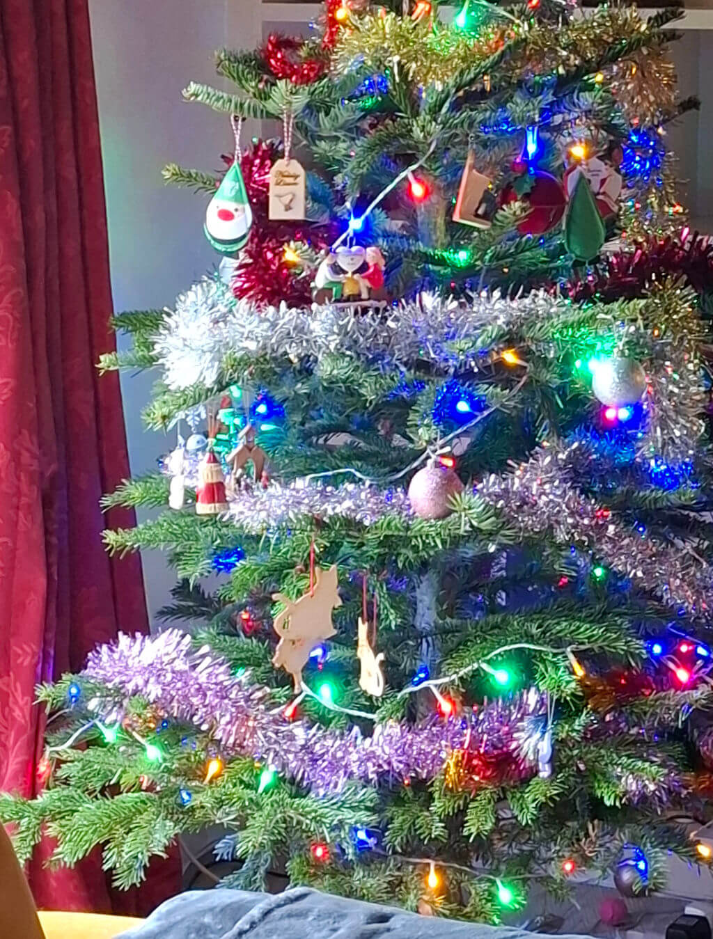 A real Christmas tree decorated with tinsel and ornaments