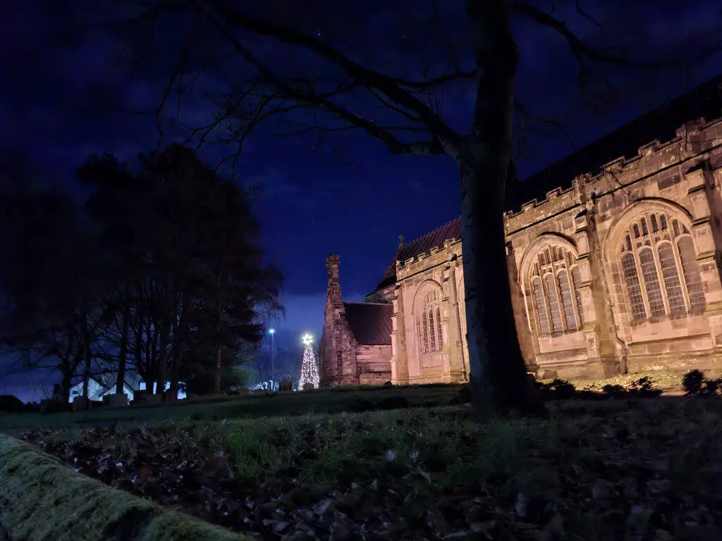 A view across Winwick church yard to the Christmas tree