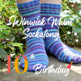 Colourful striped socks on feet in a garden; text overlay reads "Winwick Mum Sockalong 10th Birthday" with a festive hat and stars.