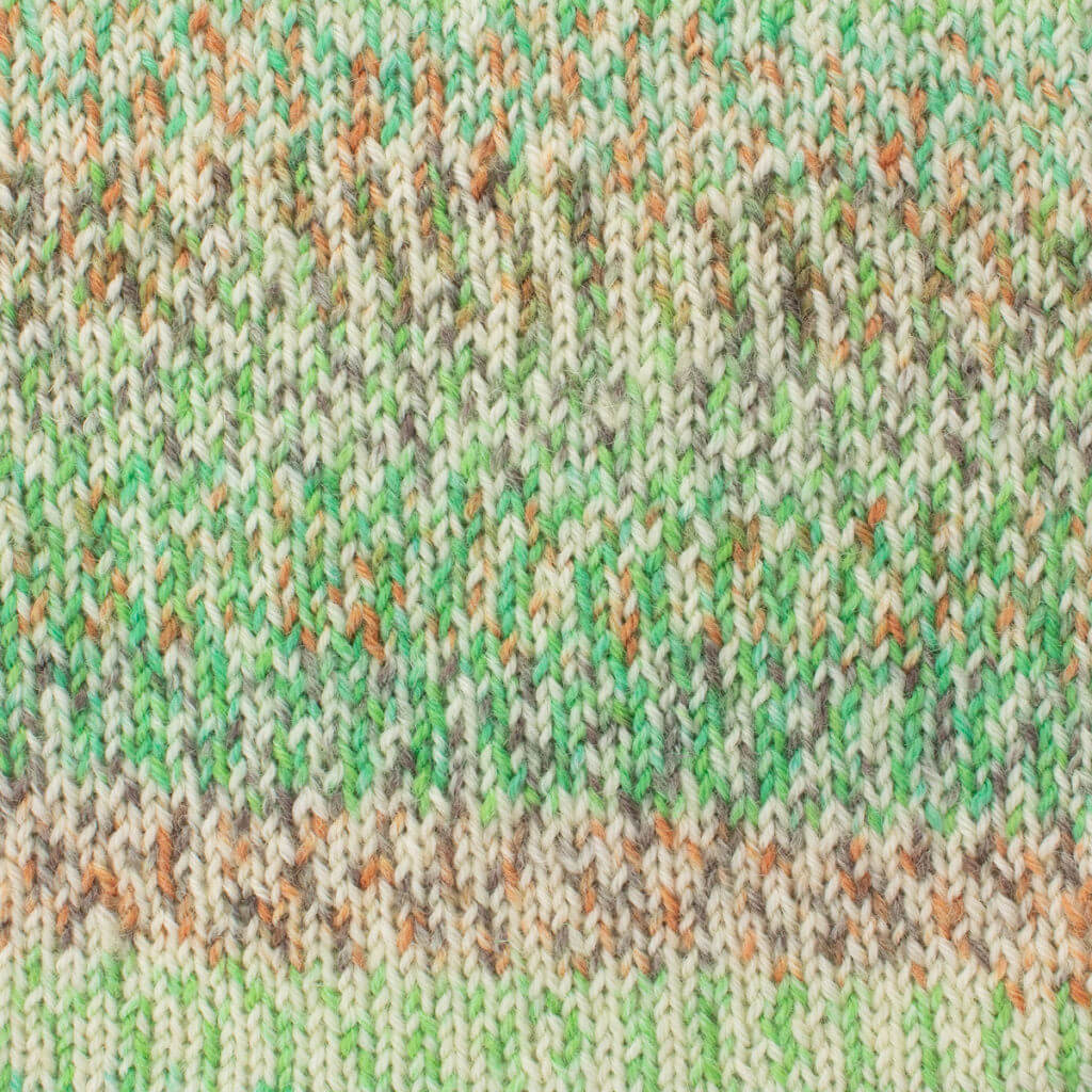 Close-up of West Yorkshire Spinners Signature 4ply Green Hairstreak knitted fabric with a colorful pattern. Features green, orange, and beige hues in a textured, zigzag design, creating a warm, cozy feel.