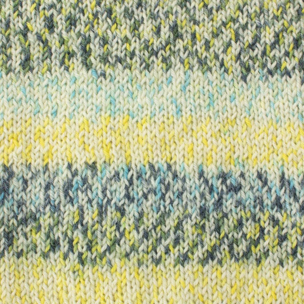 Close-up of West Yorkshire Spinners Signature 4ply, Yellow Swallowtail knitted fabric with horizontal stripes of yellow, blue, and green. The yarn texture is soft and cozy, creating a warm feel.