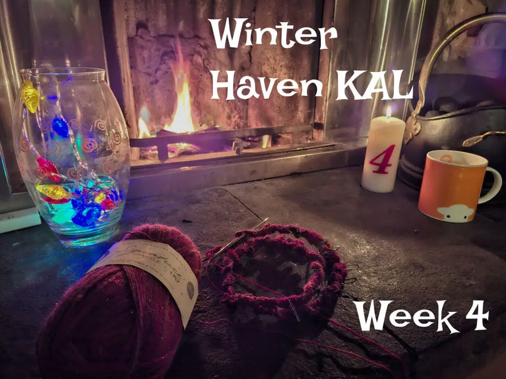 Cosy scene with knitting supplies, colourful yarn in front of a warm fireplace. A lit candle marked "4" and vibrant glass decor set a relaxing winter mood.