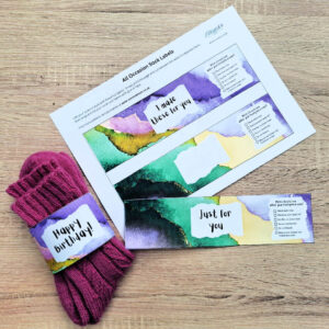 Colourful sock labels with watercolour designs, one wrapped around pink socks reading "Happy birthday!" Other labels say "I made these for you" and "Just for you."