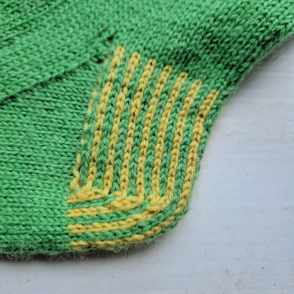 A close up of a sock heel flap knitted in two colours