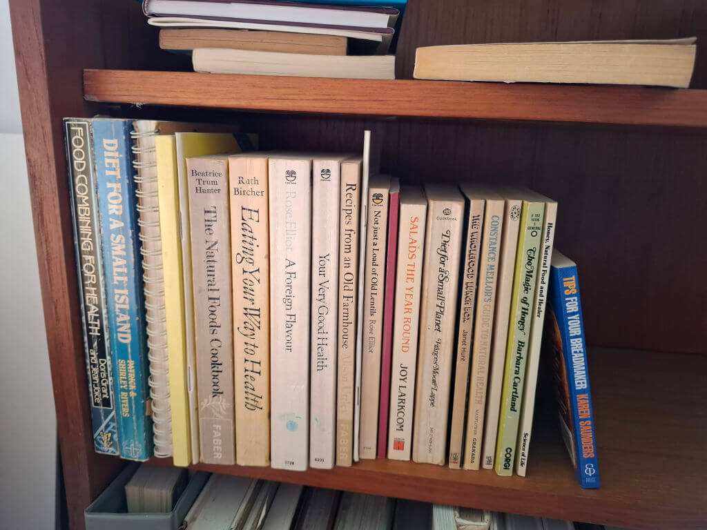 A bookshelf with a selection of cookbooks.